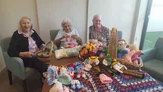 Mercy Place Mont Clare Seniors Busy Knitting Beanies for Babies