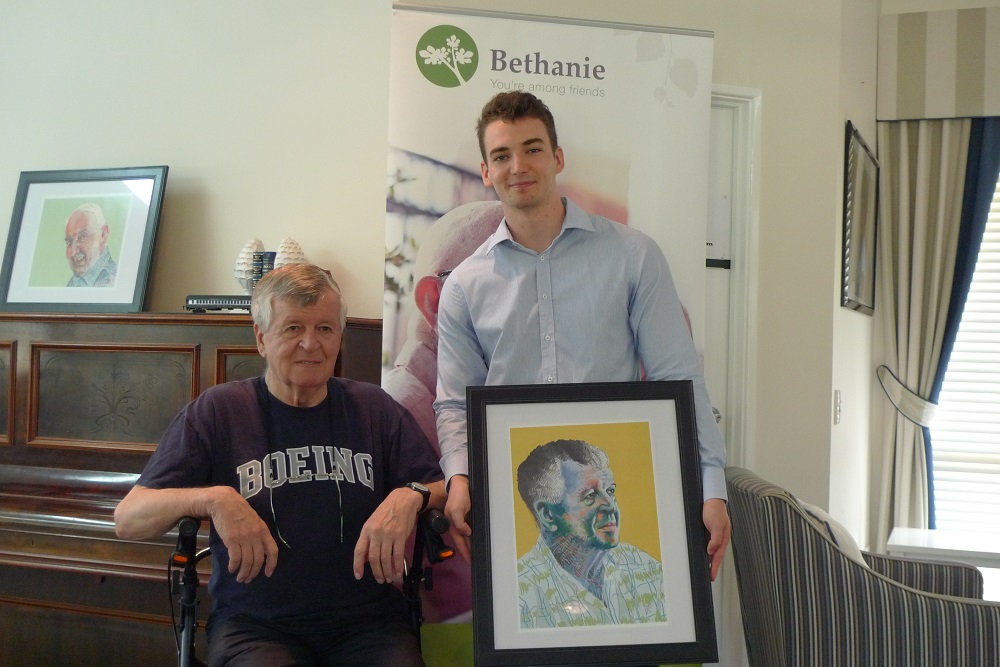 Bethanie Client Alex Hebenton, Bethanie Volunteer and artist David Chapman with a portrait of Alex 