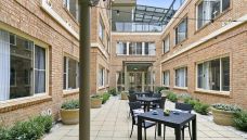 Bupa-Aged-Care-Mosman-courtyard-with-chairs-and-tables